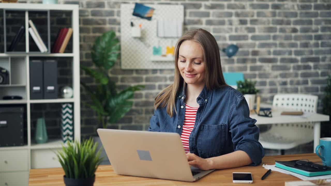 An educator working remotely on a laptop